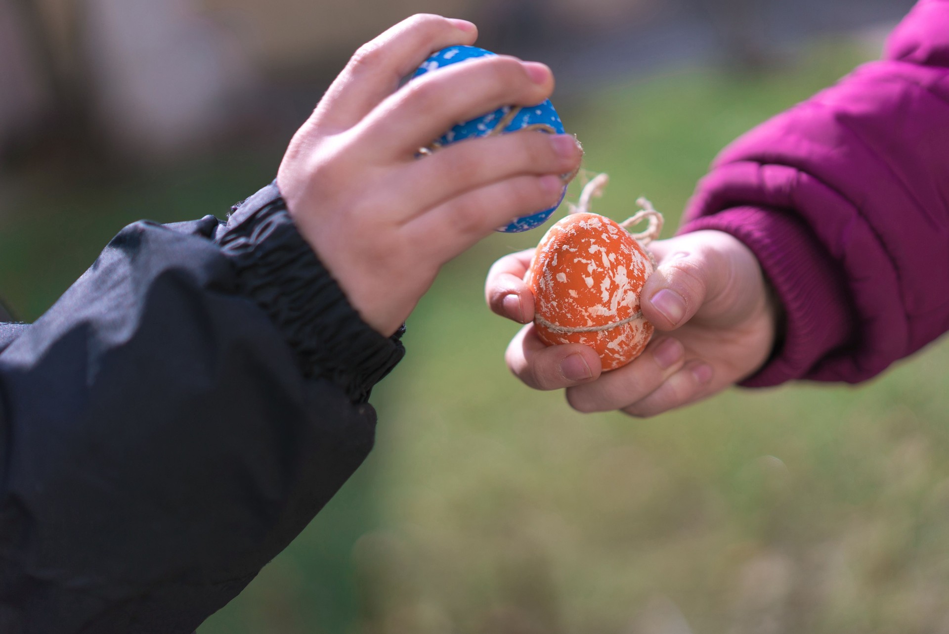 Two Kids Breaking Easter Eggs